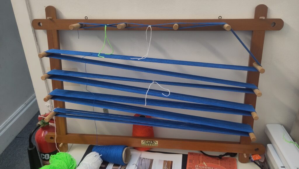 Blue thread on a warping board
